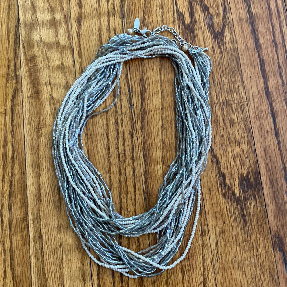 14 strand creamy tan and clear silver beaded necklace.